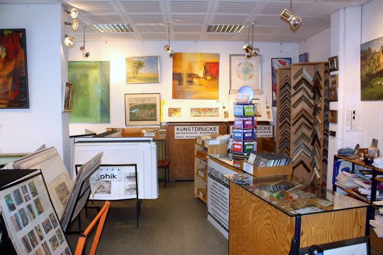 Ausstellungsbereich mit Rahmenmuster-Ständern, Kunstdrucken und Grafiken